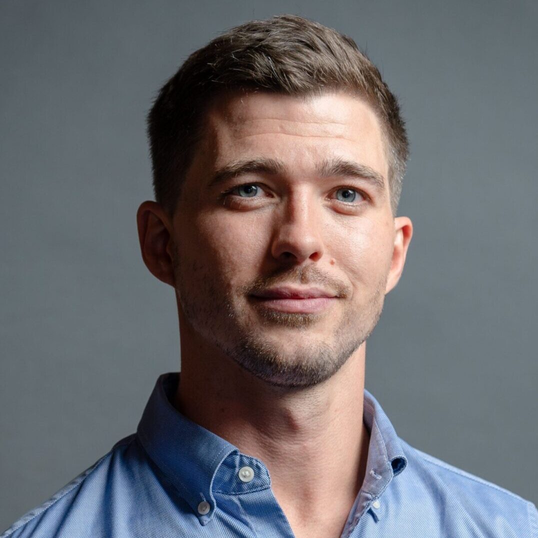 Headshot of young man in blue shirt
