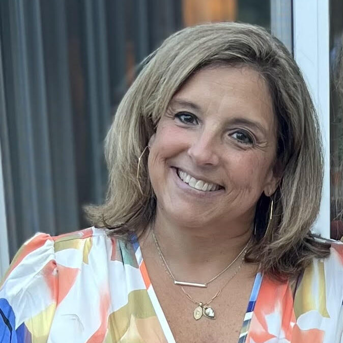Smiling woman wearing colorful dress and necklaces